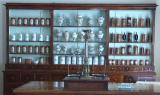 The inlaid furniture, scales and dishes of the pharmacy