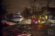 2012.10.30, Rockaway, New York, USA. A Sandy hurrikán által bekövetkezett árvíz a fóutra sodorta a közeli kikötöben álló jachtot. 2012.10.30, Rockaway, New York, USA. A Sandy hurrikán által bekövetkezett árvíz a fóutra sodorta a közeli kikötöben álló jachtot.